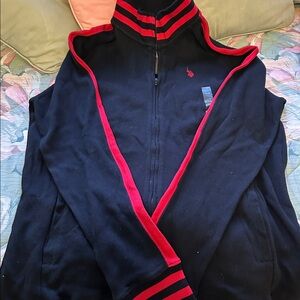 Full zip sweater with long sleeves. Black with red accents.